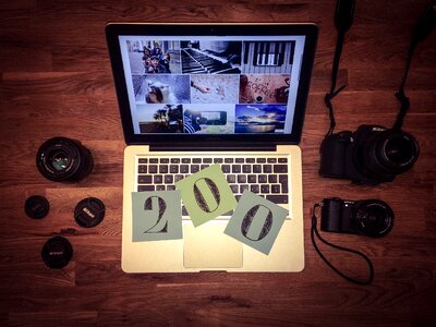 White Laptop Computer Near Black Dslr