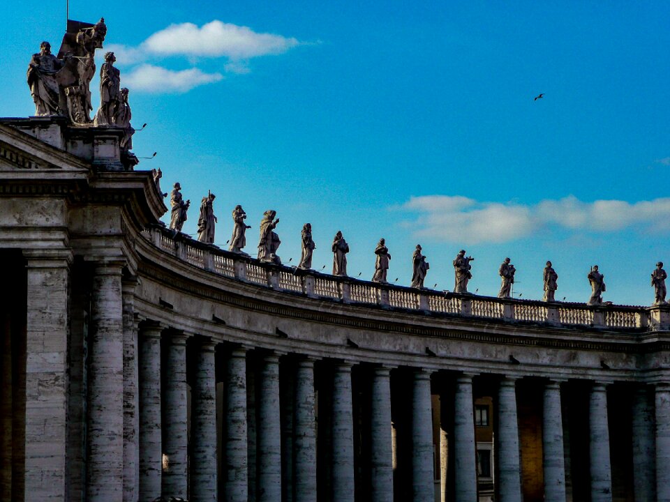 Brown Concrete Building With Human Concrete Statues during Daytime photo