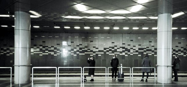 Woman Wearing Gray Coat Standing on Train Station photo