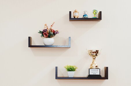 Brown Wooden Floating Shelves Mounted on Beige Painted Wall photo