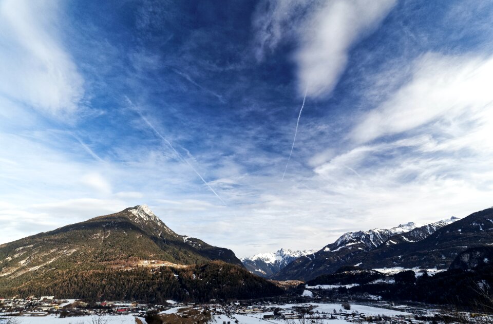 Green Mountain With Snow Field Under Blue Sky and White Clouds photo