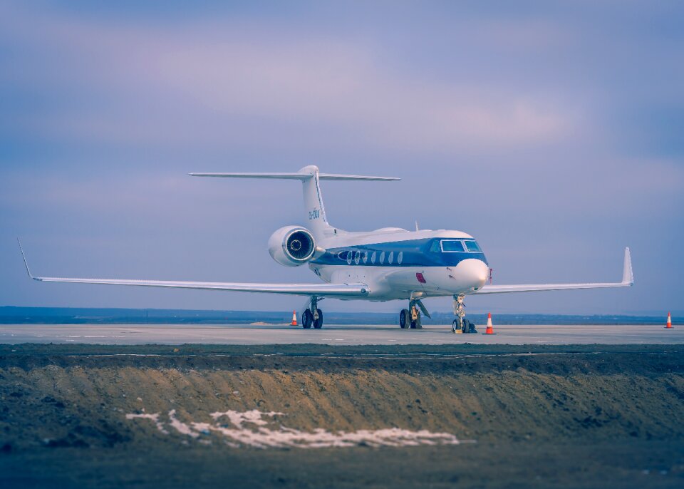 Blue and White Airplane on Concrete Ground photo