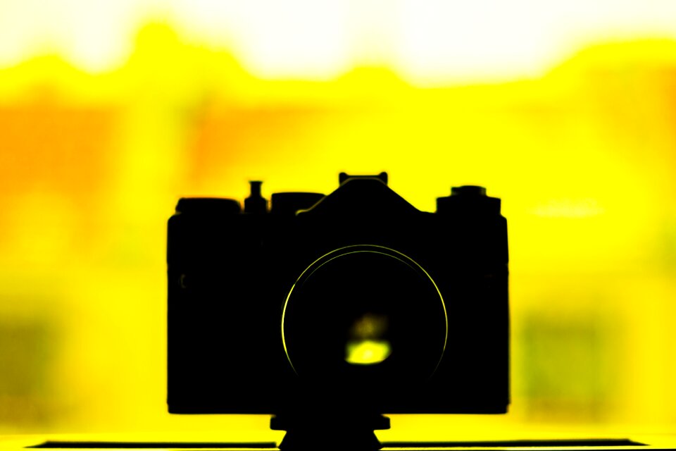 Silhouette Photo of Camera on Yellow Background