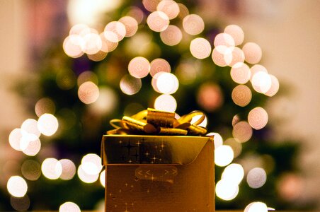 Gold-colored Gift Box With White Bokeh Background photo
