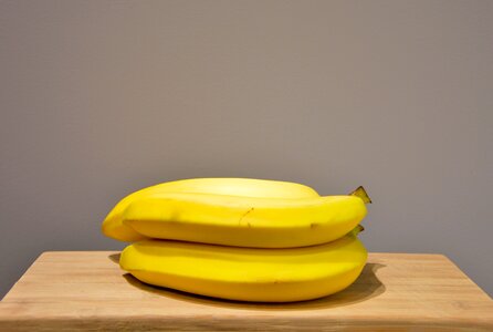 Yellow Bananas on an Oak Wood Table photo
