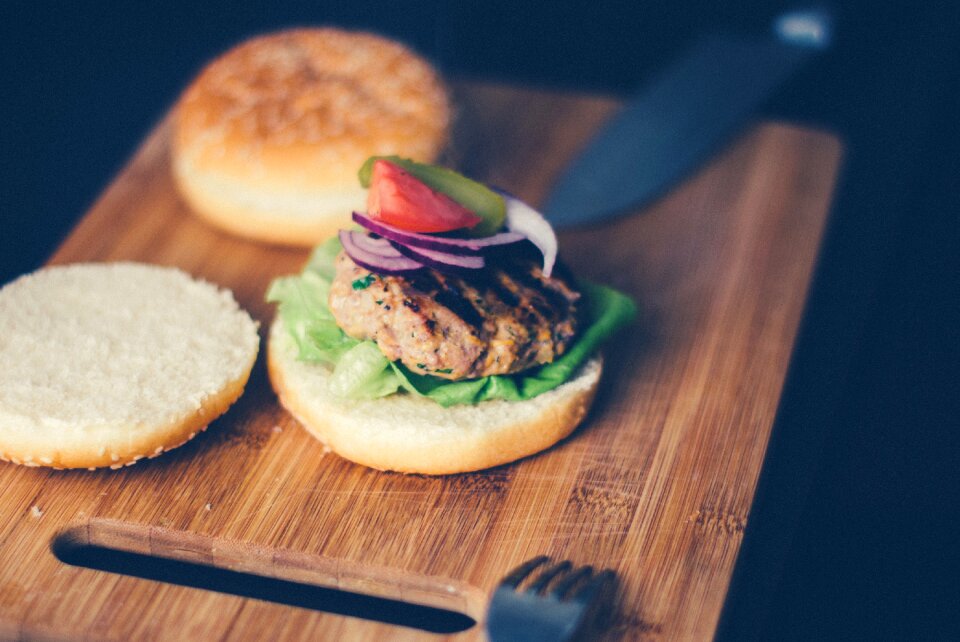 Shallow Focus Photography of Burger Sandwich Served on Brown Wooden Chopping Board