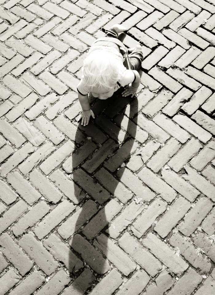 Baby Crawling on Brown Bricks during Daytime