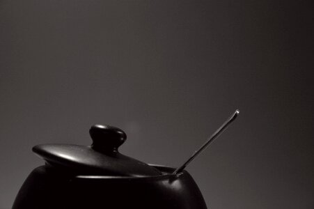 Black Cooking Pot With Stainless Steel Spoon photo