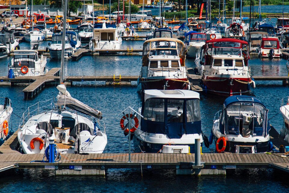 White Blue Sailboats Dock on Water during Daytime photo