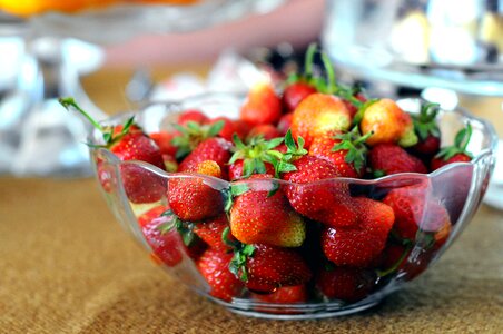 Red Strawberries in Clear Glass Bowl on Brown and Gray Textile photo