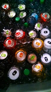 Drinking Cans and Bottle on Water With Ice Cubes photo