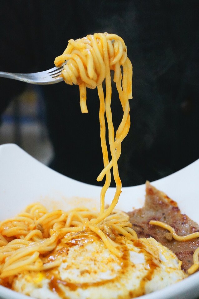 Gray Steel Fork With Yellow Pasta