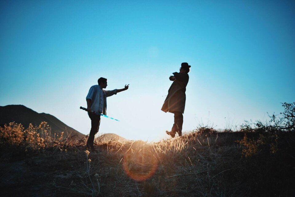 2 Man Standing on Mountain during Day Time