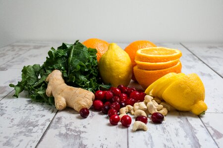 Lemon Orange Red Berries Ginger Peanut on Wooden Table