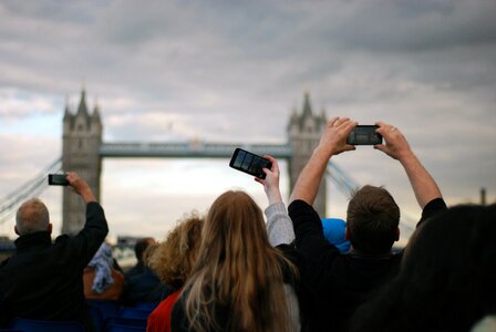 People Taking Picture at Tower Bridge Under Gray Clouds photo