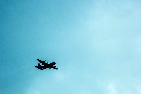 Airplane Against Blue Cloudy Sky Overhead photo