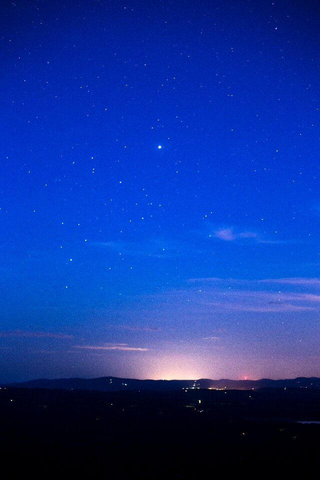 Silhouette of Mountain Range Under Stars