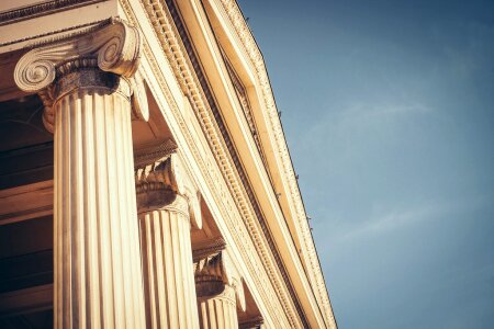 Brown Concrete Building With Pillars Against Clear Skies photo