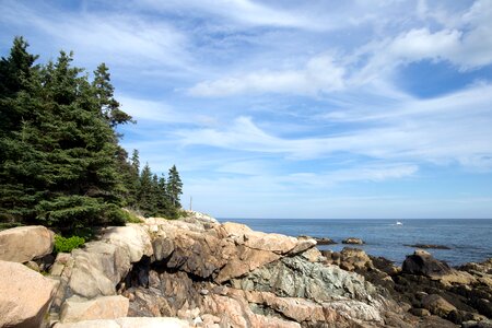 Green Trees Near Brown Cliff and With Overview of the Sea photo