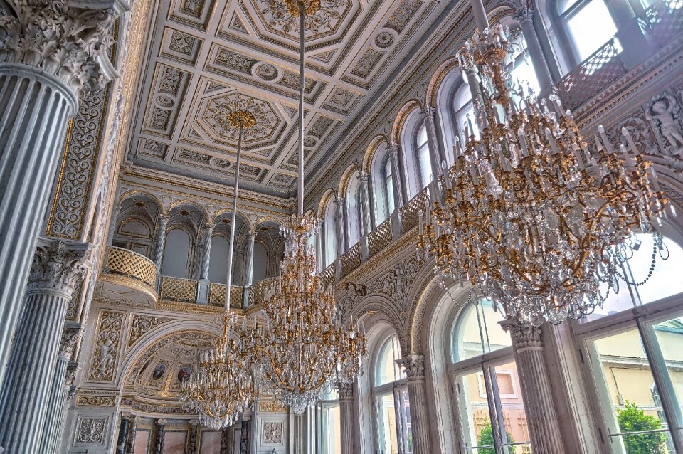 White Cathedral Hanging With Three Brown Uplight Chandelier photo