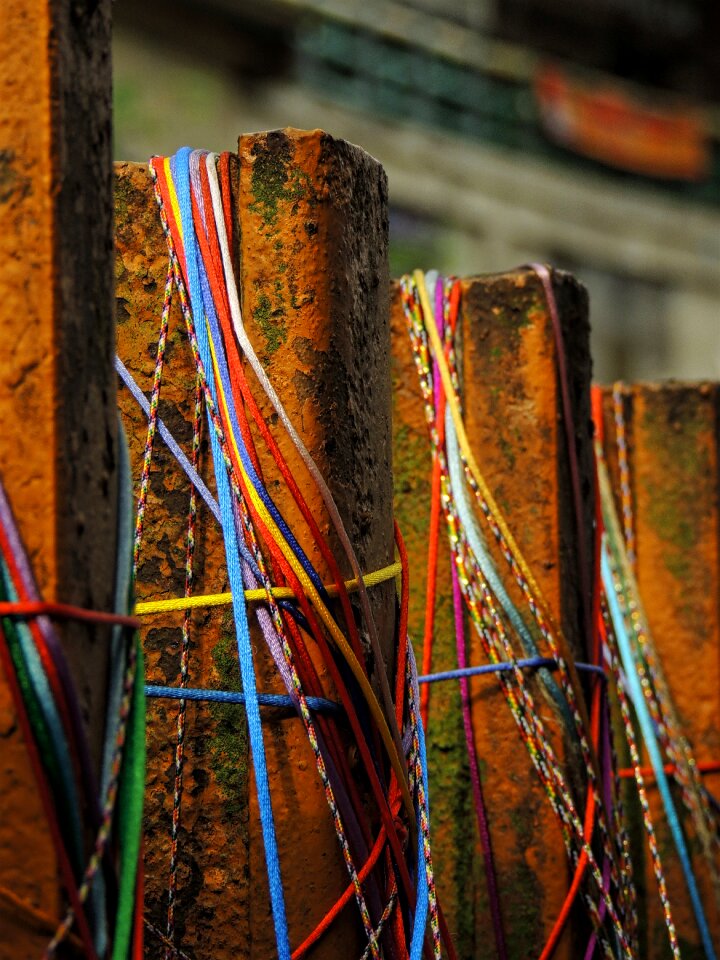 Brown Metal Fence With Blue Red and Yellow Rubber Band Selective Focus Photo