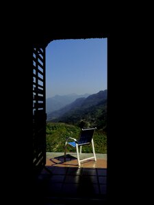 Blue and White Empty Armchair during Daytime Outside With Mountain Range Under Blue Sky during Daytime photo