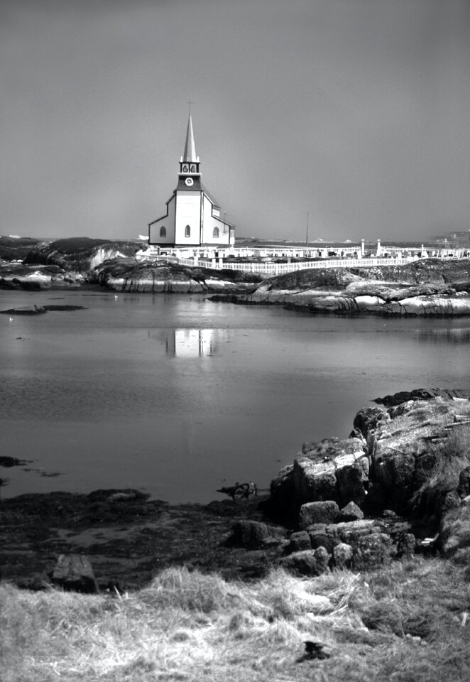 White Church Next to Body of Water