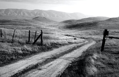 Grayscale Photo of Road and Mountain at Daytime photo