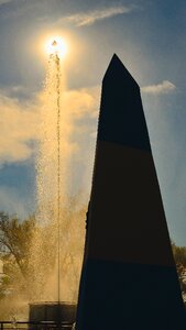 Black Tower Near Fountain Under Blue Sky and White Clouds photo