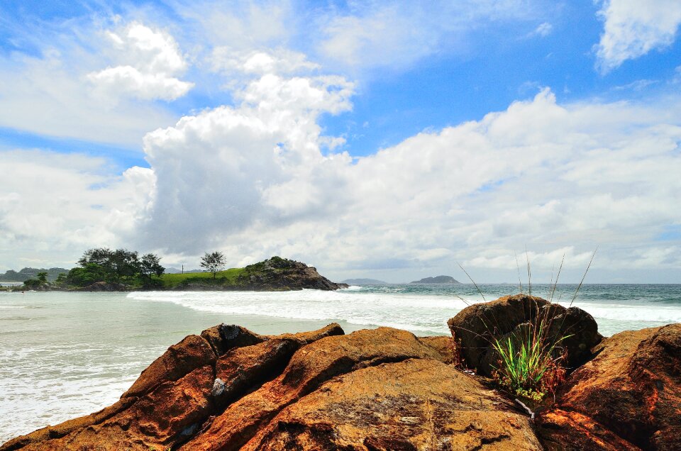 Green Island Under White Clouds and Blue Sky at Daytime photo