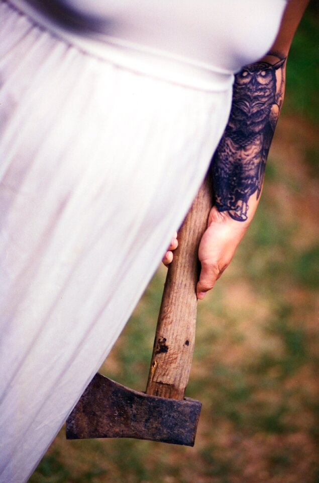 Women in White Dress Holding Axe