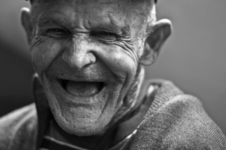 Grayscale Photo of Laughing Old Man photo