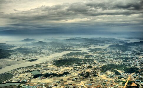 Aerial View Photo of Urban Area and Mountain Range in the Distance Under Gray Cloudy Sky photo