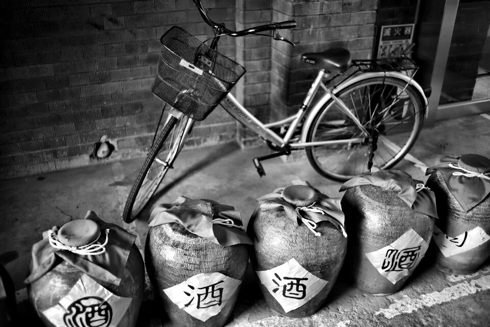 Grayscale Photography of Dutch Bike Behind Jars