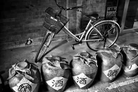 Grayscale Photography of Dutch Bike Behind Jars photo