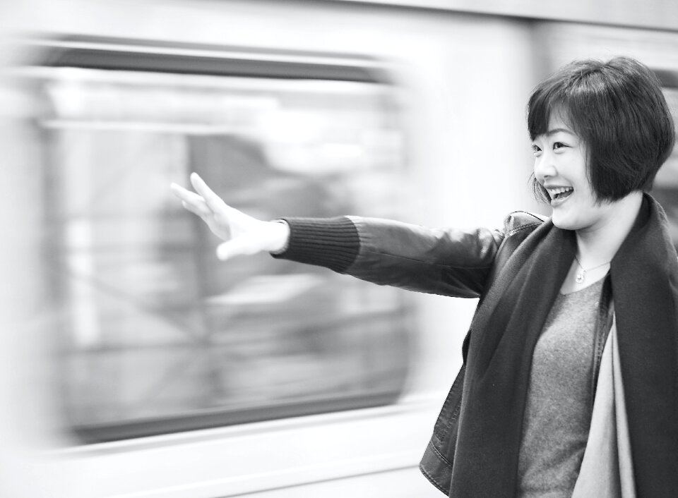 Grayscale Photography of Woman Raising Right Arm photo