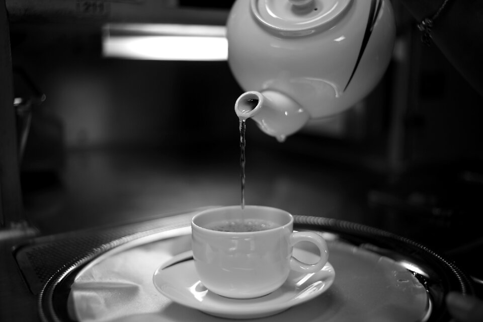 Timelapse Photography of Water Pouring from White Ceramic Teapot to White Ceramic Mug on White Saucer photo