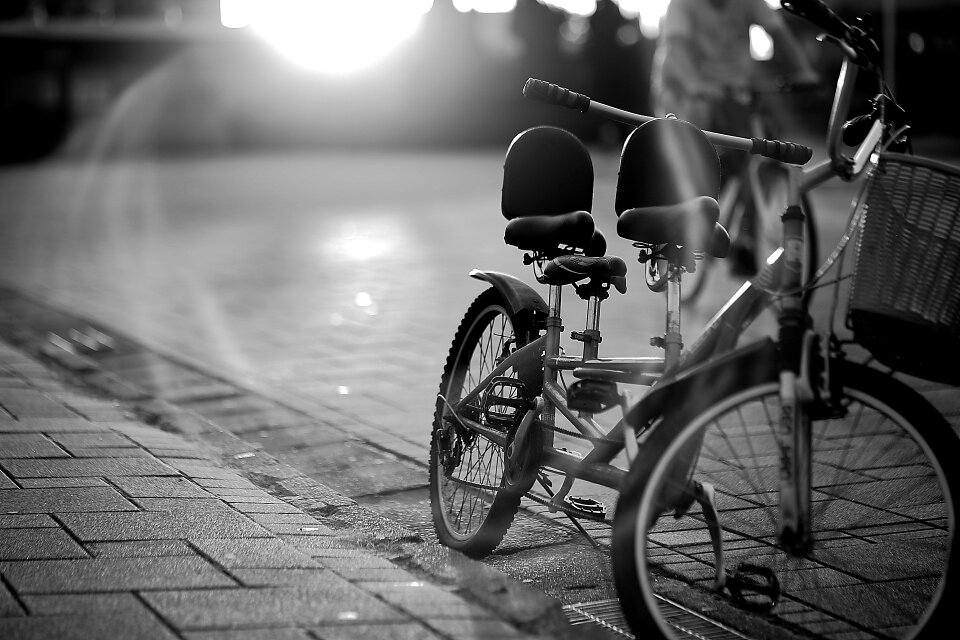 Tandem Bicycle on Sidewalk in Greyscale Photography