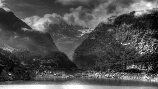 Grey Scale Photo of Body of Water Near Mountain Ranges photo