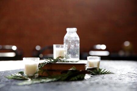 Clear Glass Bottle Beside Candle Holder