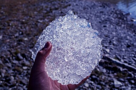 Person Holding Clear Stone photo