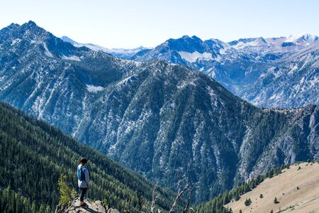 Person Standing on Cliff Watching Overview Mountain photo