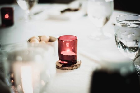 White and Red Votive Candle on Table photo