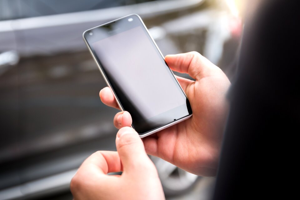 Person Holding Android Smartphone Displaying Black Screen photo