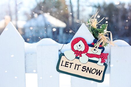 Let It Snow Signage Hanging on Fence photo