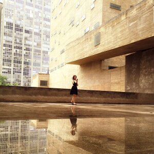 Woman Wearing Black Mini Dress Standing on the Concrete Floor photo