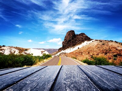 Scenic View of Mountain Road Against Blue Sky photo