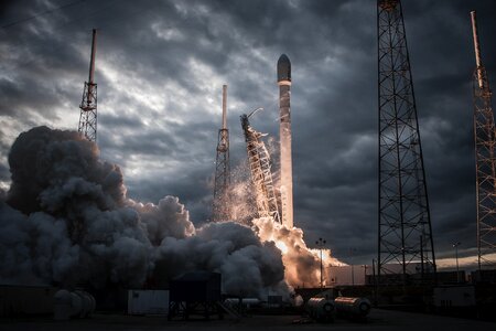 Space rocket taking off on overcast day photo