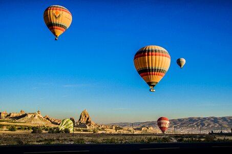 Four Beige Hot Air Balloons Flying photo