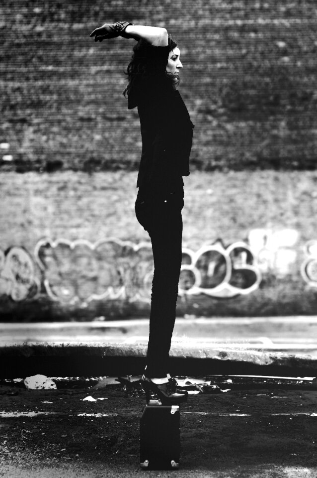 Grayscale Photo of Woman in Black Short-sleeved Shirt and Black Pants